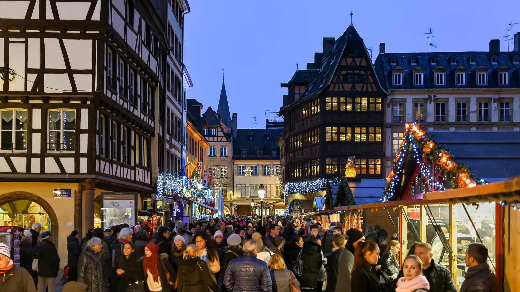 Christmas stalls and half-timbered houses in Strasbourg at dusk